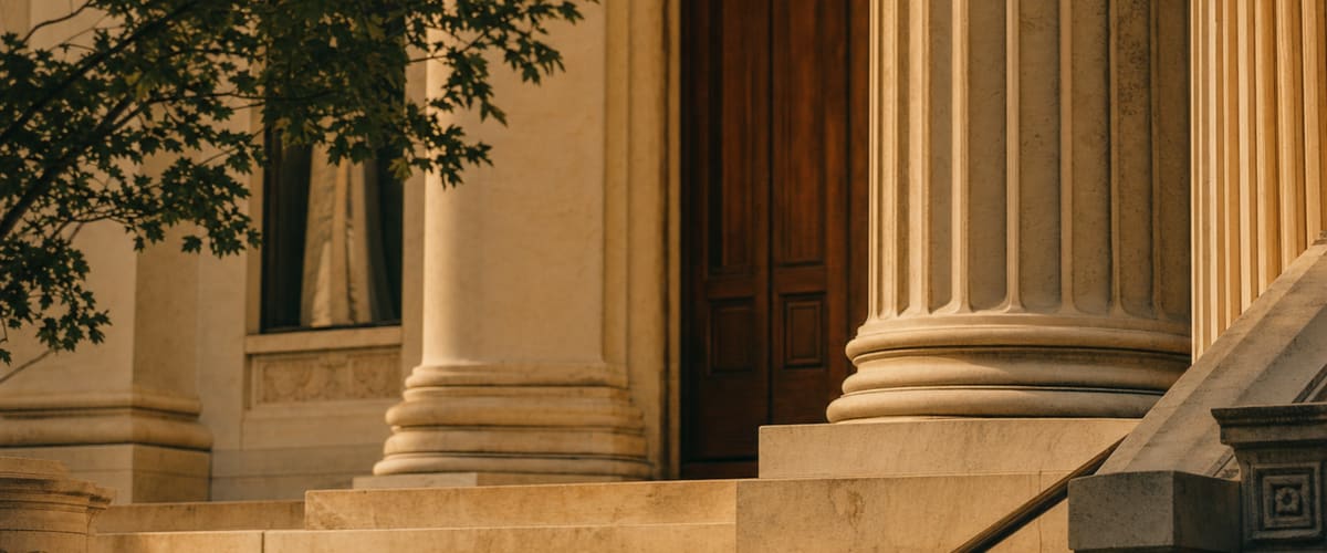 A dignified civic building with stone columns in warm afternoon light